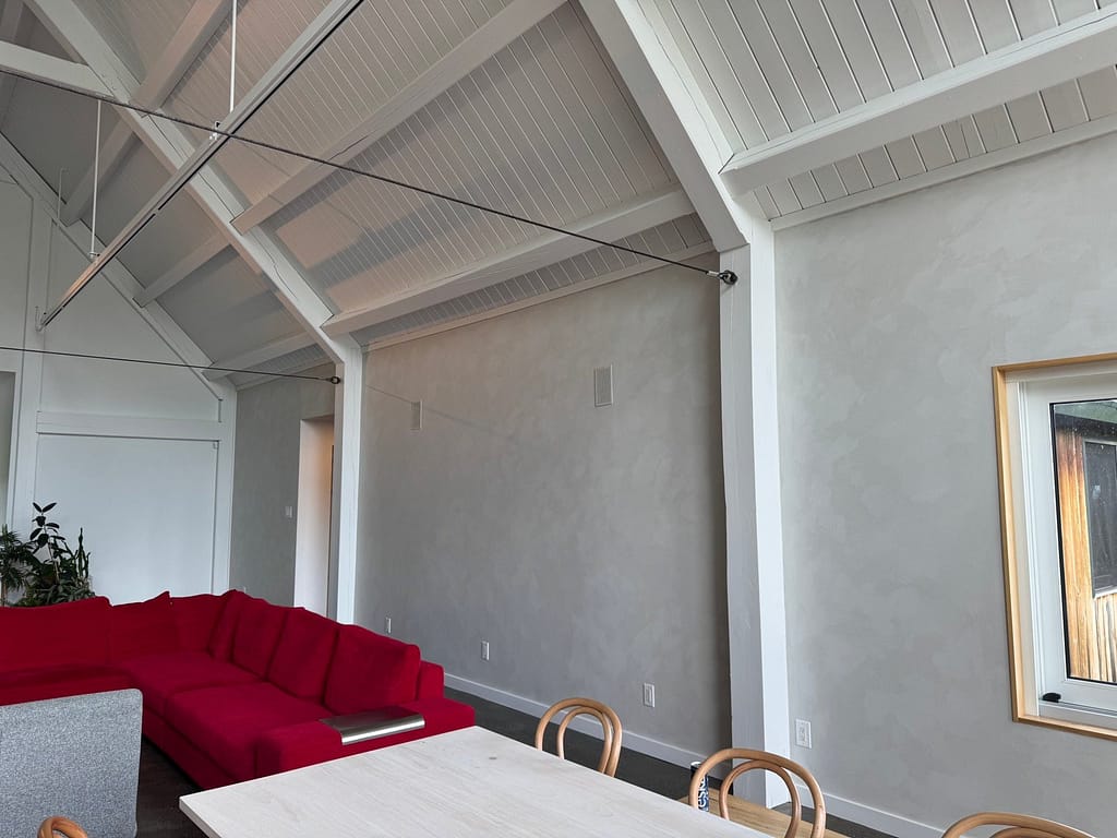 Soft grey lime wash feature wall in an Ottawa living room with vaulted ceiling