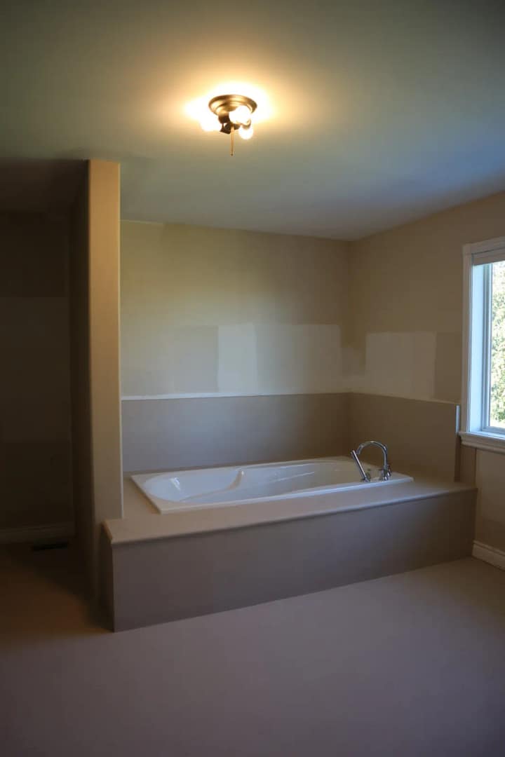 The same tub deck after being covered in seamless warm microcement