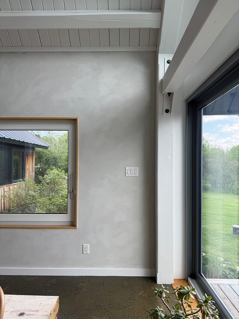 Pale grey lime wash wall and skylight in a sunlit Ottawa room